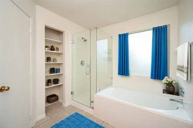 a white bath tub sitting next to a bathroom