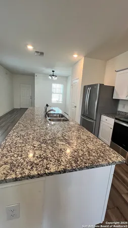 a kitchen with kitchen island sink stove and refrigerator