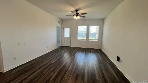 wooden floor in an empty room with a window
