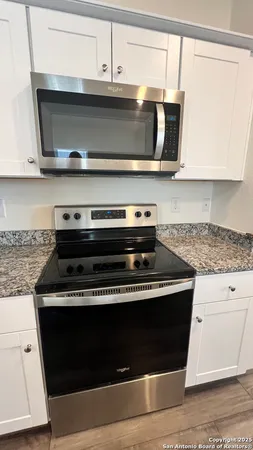 a stove top oven sitting inside of a kitchen