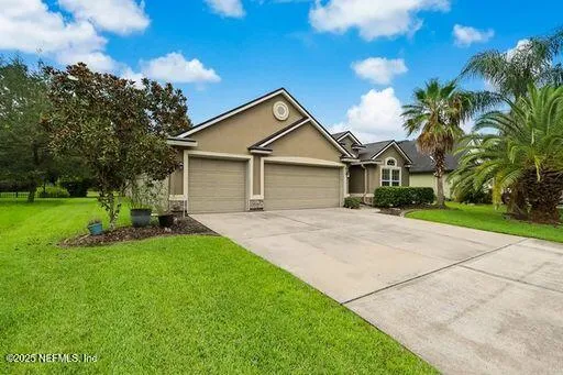 a front view of house with yard and green space