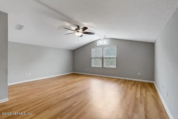 a view of an empty room with a ceiling fan