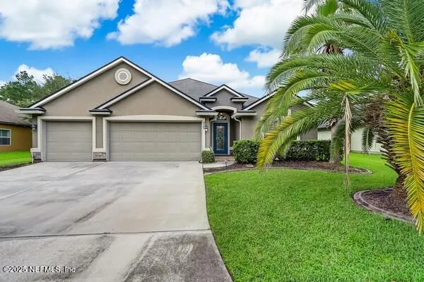 a house with green field in front of it