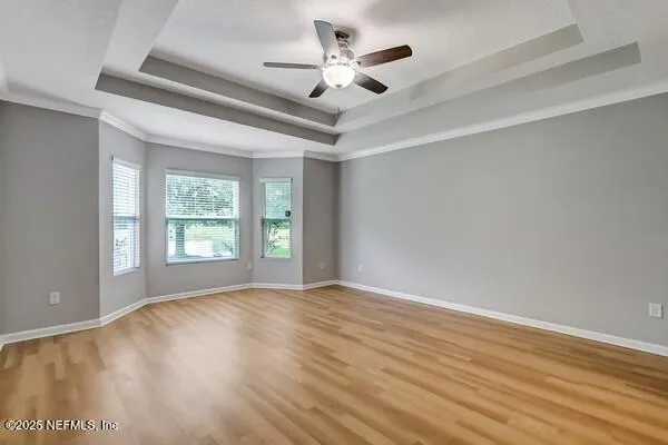 a view of a livingroom with a ceiling fan and window