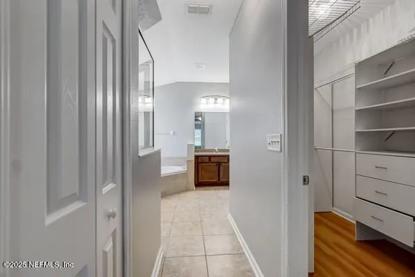 a bathroom with a tub and a sink