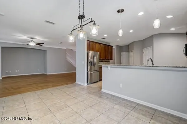a kitchen with stainless steel appliances granite countertop a sink stove and microwave