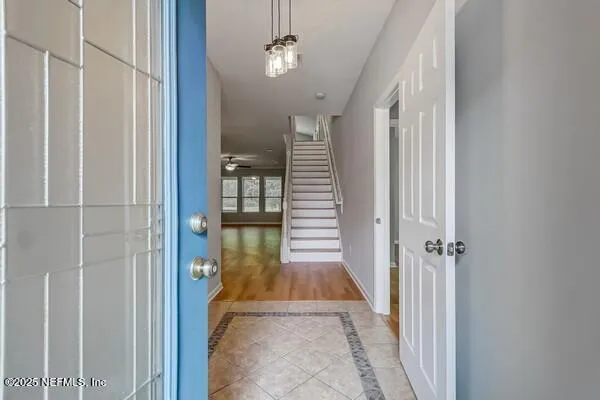 a view of a hallway with entryway wooden floor and front door