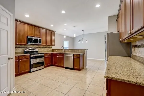 a view of a house with backyard and a tree