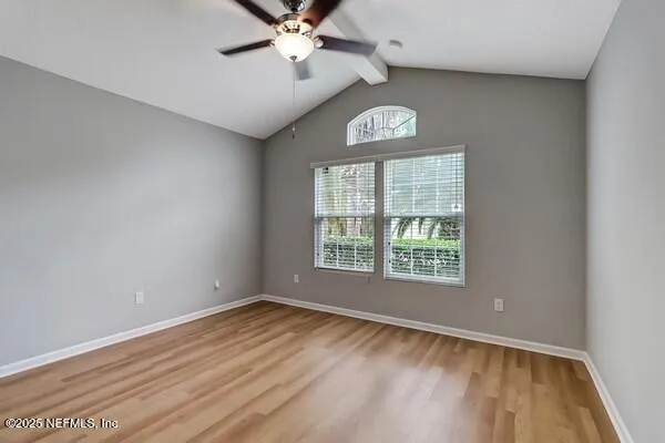 a view of empty room with wooden floor