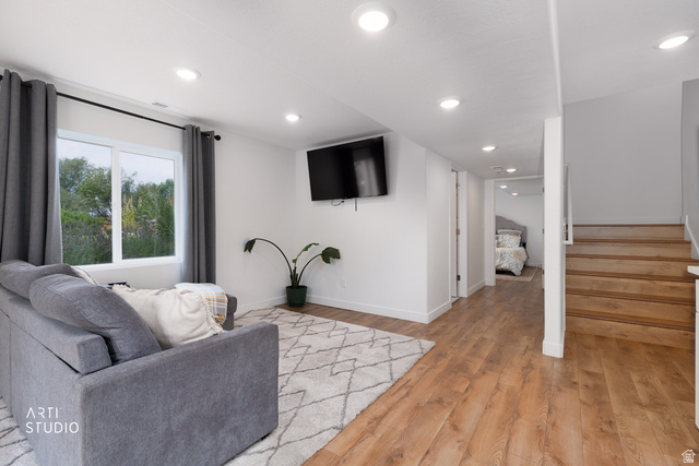 1654 South 730 West Provo, UT 84601 - Photo 22 of 33 Open-concept living space featuring wood-finish flooring, recessed lighting, white walls, and a prominent window