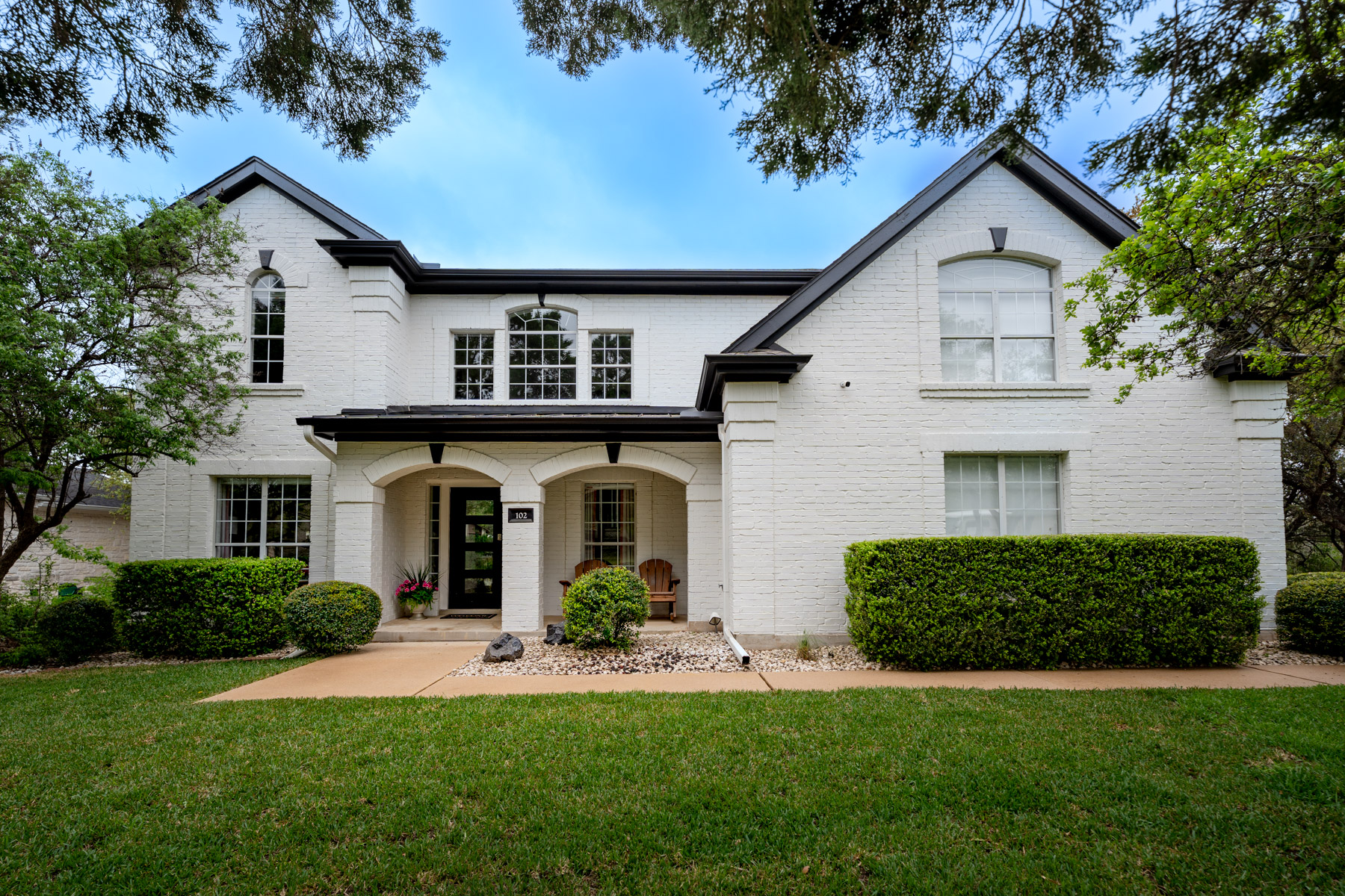 102 Hurst Creek Road Lakeway, TX 78734 - Photo 1 of 29 a front view of a house with a yard and garage