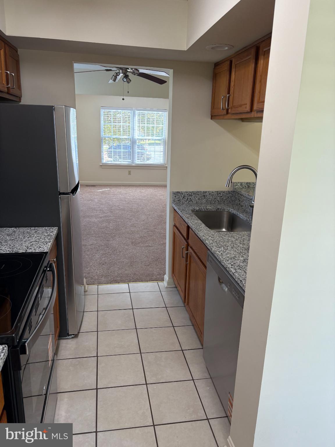 4342 Downs Square Belcamp, MD 21017 - Photo 6 of 30 a kitchen with granite countertop a stove a sink and a refrigerator