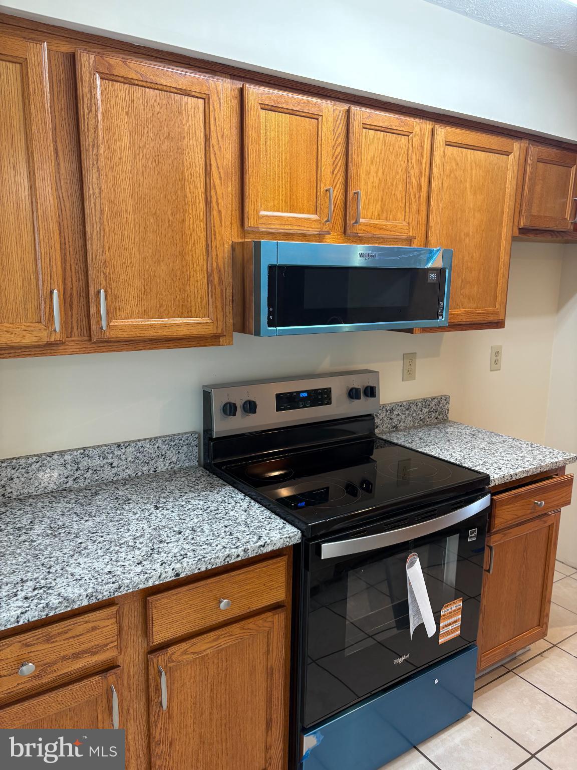 4342 Downs Square Belcamp, MD 21017 - Photo 9 of 30 a kitchen with wooden cabinets and a stove top oven