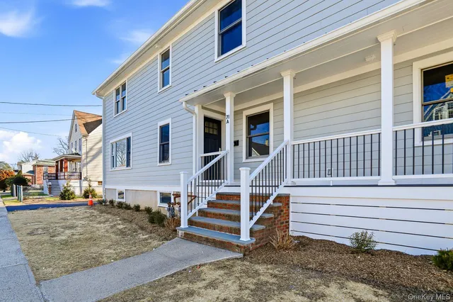a view of a house with wooden fence