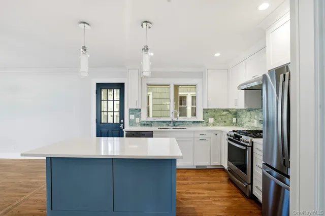 a kitchen with stainless steel appliances granite countertop a sink and stove