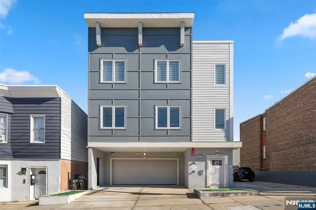 a front view of a house with garage