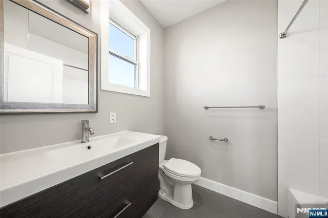 a room with a bed and wooden floor