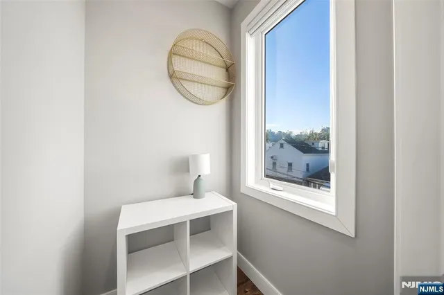 a view of entryway and hall with wooden floor