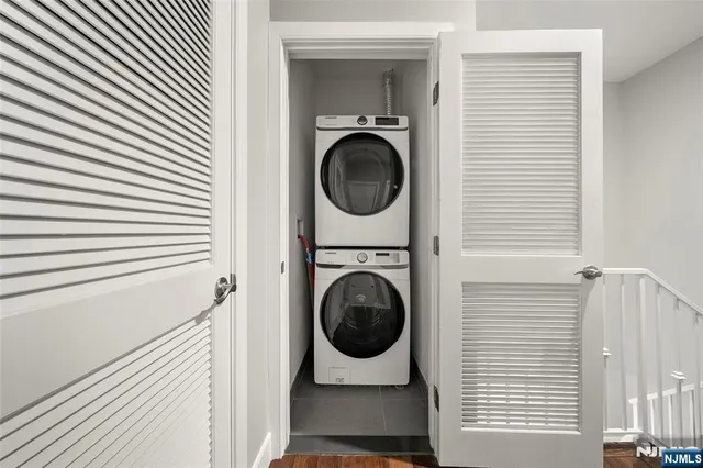 a backyard of a house with large trees and outdoor seating