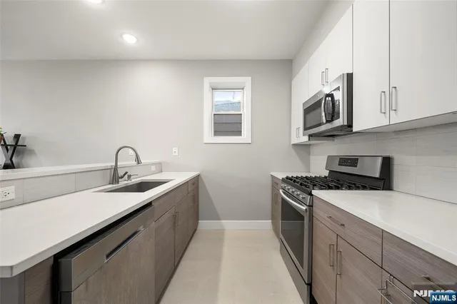a bathroom with a toilet a sink a vanity and mirror
