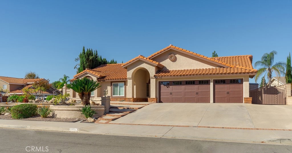 a front view of a house with a garden