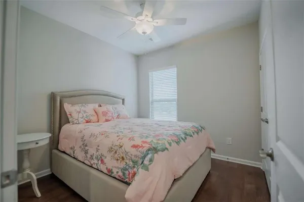 a bedroom with a bed and a ceiling fan