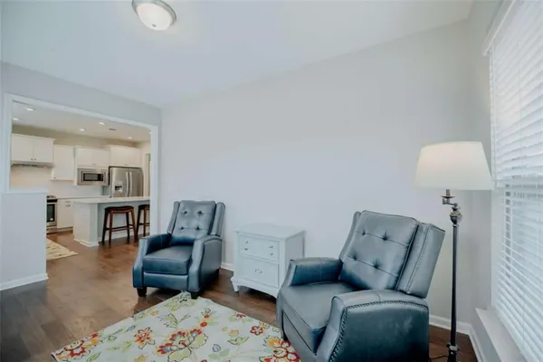 a living room with furniture and a lamp