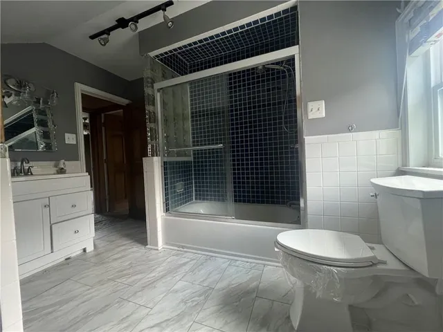 a bathroom with a toilet a sink and shower
