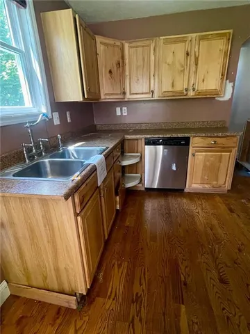 a kitchen with wooden floors and a sink