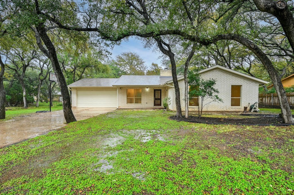 3804 Brangus Road Georgetown, TX 78628 - Photo 1 of 1 a view of a house with a backyard and a tree