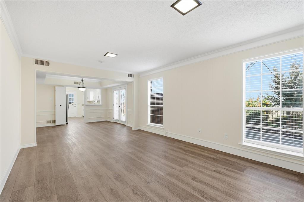 2145 Willow Place, Unit B Carrollton, TX 75006 - Photo 13 of 39 a view of empty room with wooden floor and window