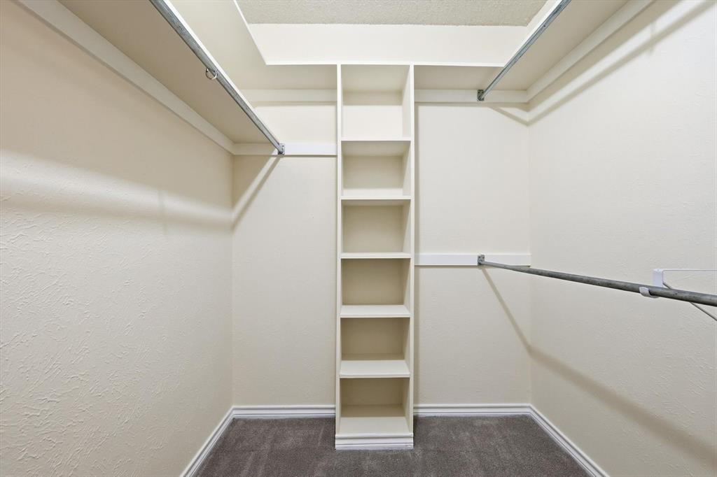 2145 Willow Place, Unit B Carrollton, TX 75006 - Photo 23 of 39 a view of walk in closet with empty racks