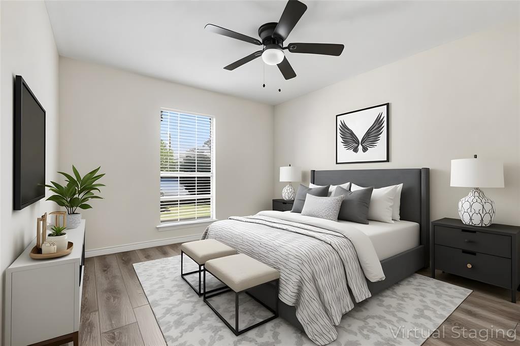 2145 Willow Place, Unit B Carrollton, TX 75006 - Photo 24 of 39 a bedroom with a bed and a potted plant