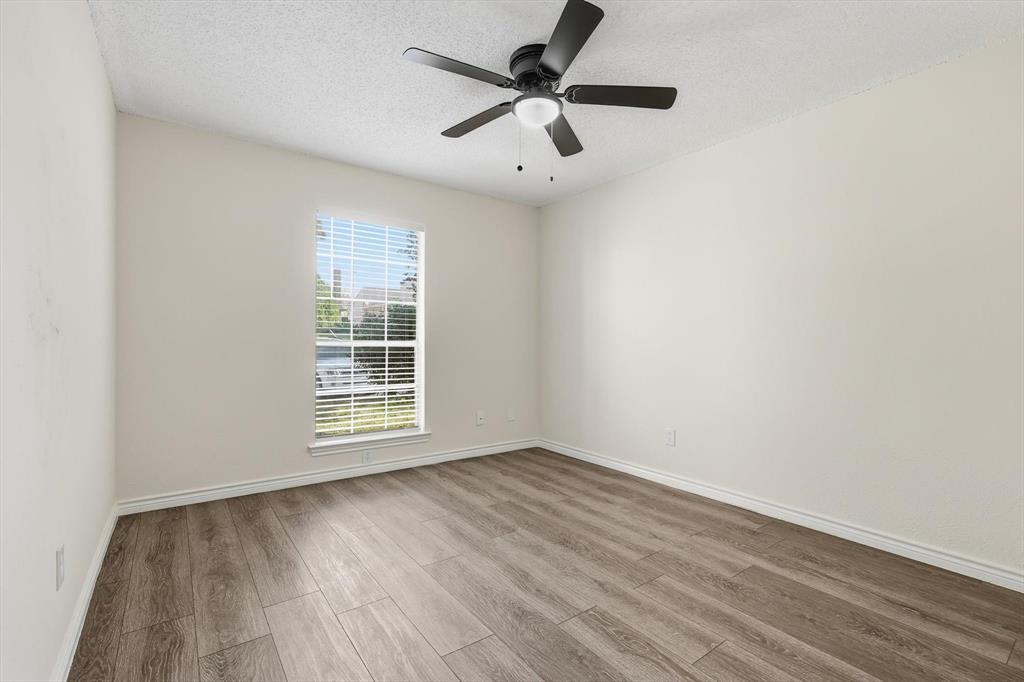 2145 Willow Place, Unit B Carrollton, TX 75006 - Photo 25 of 39 wooden floor in an empty room with a window