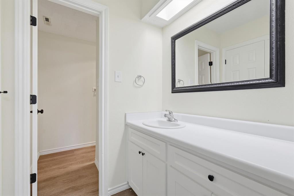 2145 Willow Place, Unit B Carrollton, TX 75006 - Photo 26 of 39 a bathroom with a sink and a mirror