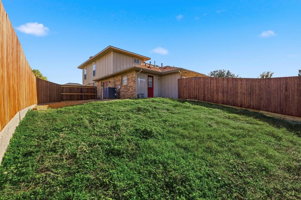 2145 Willow Place, Unit B Carrollton, TX 75006 - Photo 32 of 39 a view of a house with a yard and fence