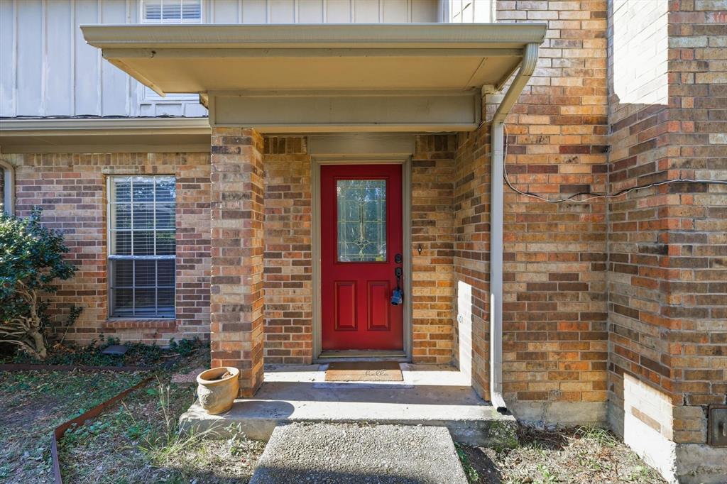 2145 Willow Place, Unit B Carrollton, TX 75006 - Photo 4 of 39 a front view of a house with a red gate