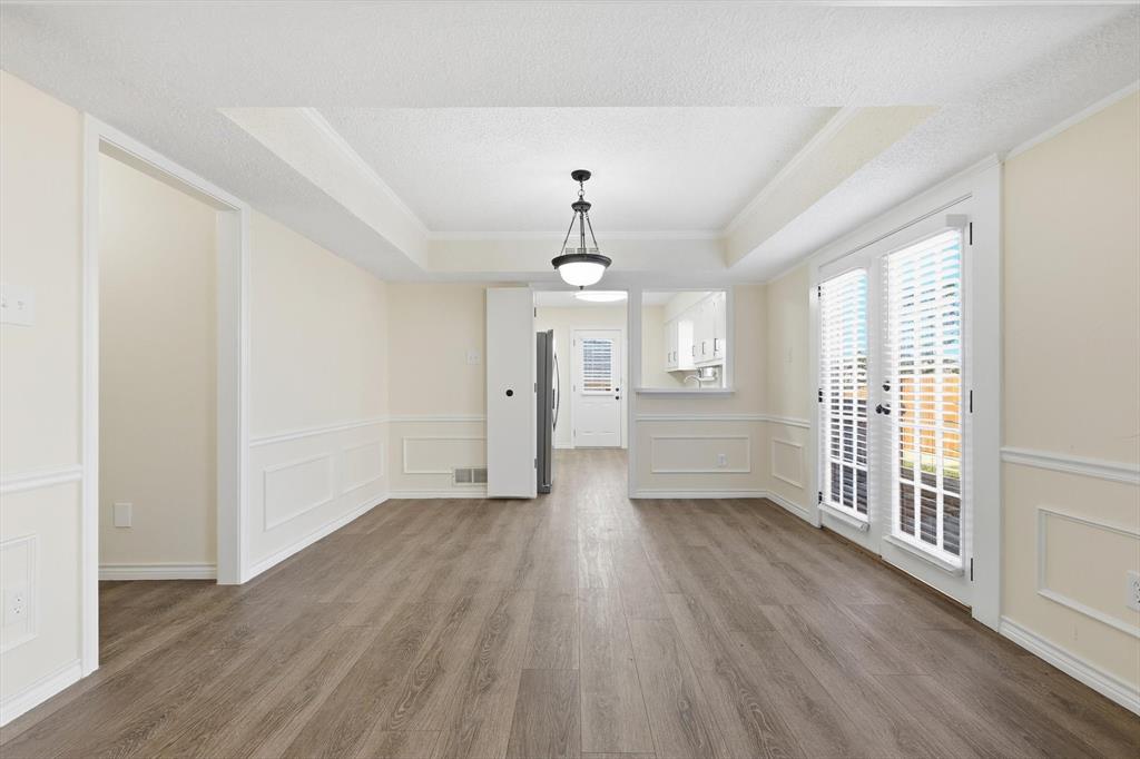 2145 Willow Place, Unit B Carrollton, TX 75006 - Photo 8 of 39 a view of an empty room with wooden floor and a window