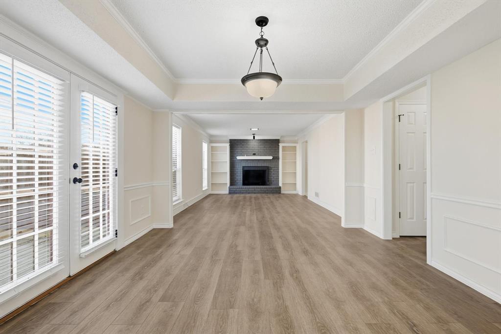 2145 Willow Place, Unit B Carrollton, TX 75006 - Photo 9 of 39 wooden floor in an empty room with a window