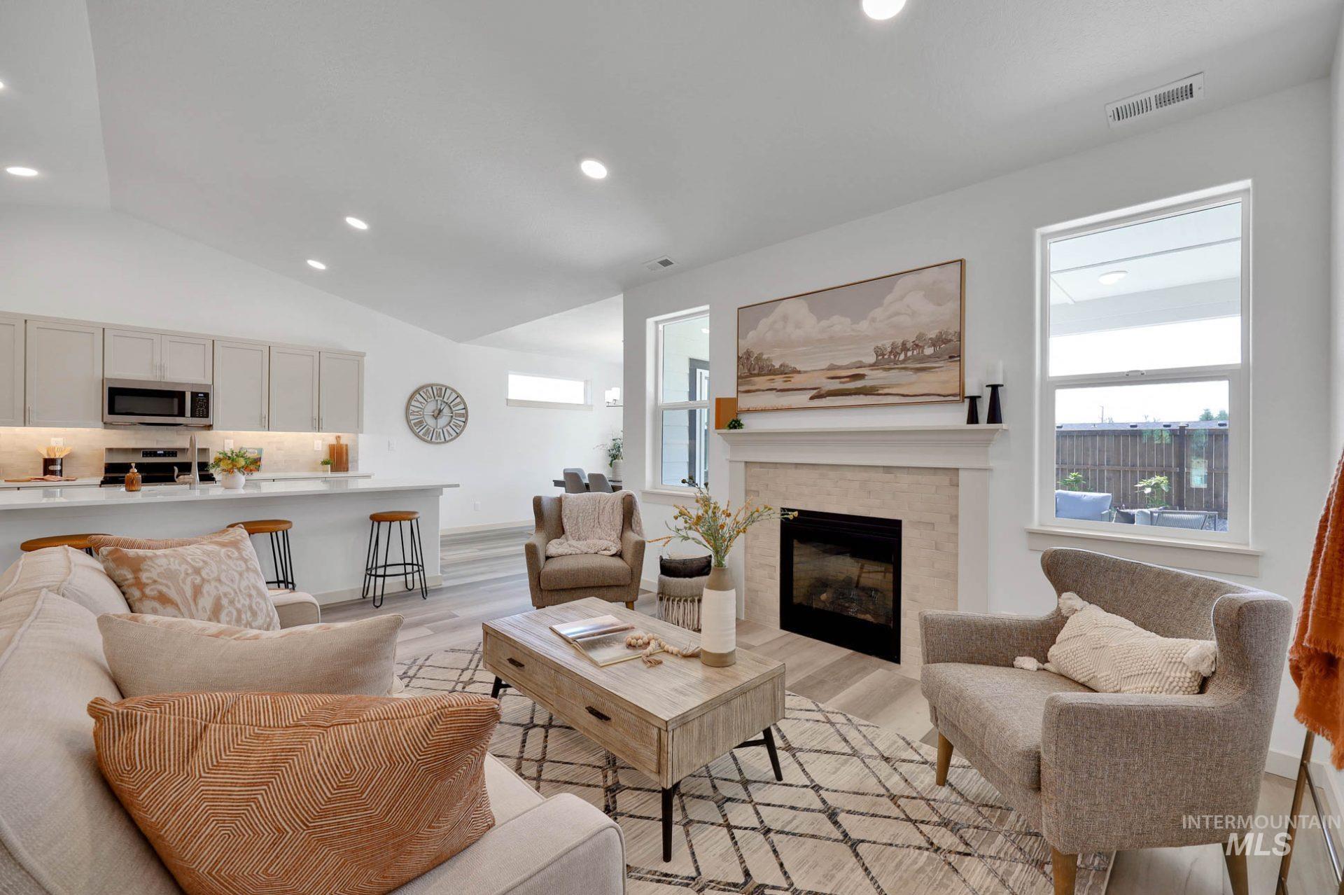 899 North Belgian Way Kuna, ID 83634 - Photo 7 of 23 Living room featuring healthy amount of natural light, recessed lighting, a fireplace, light wood-style floors, and vaulted ceiling