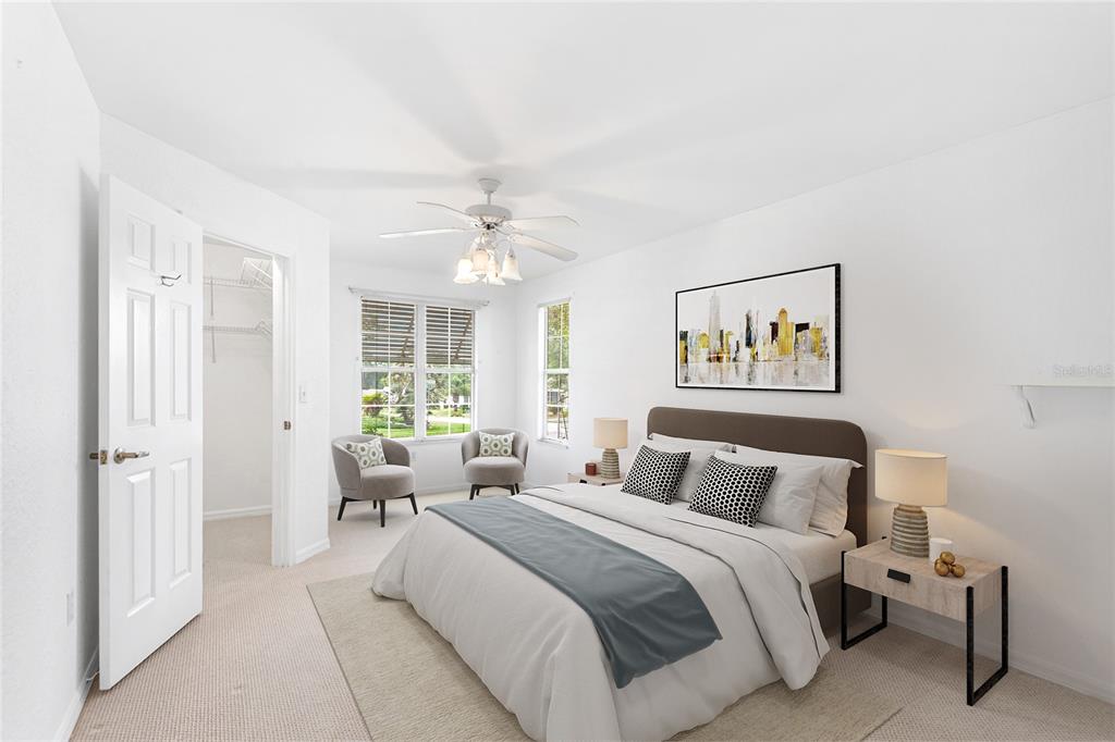 8297 Southwest 108th Loop Ocala, FL 34481 - Photo 11 of 14 a bedroom with a bed and a chandelier