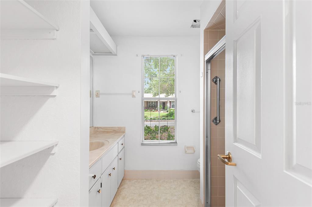 8297 Southwest 108th Loop Ocala, FL 34481 - Photo 12 of 14 a bathroom with a window a sink and a shower