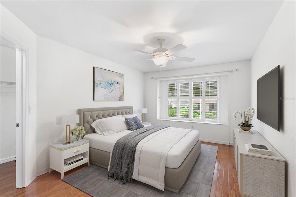 8297 Southwest 108th Loop Ocala, FL 34481 - Photo 8 of 14 a bedroom with a large bed and a flat tv screen on dresser