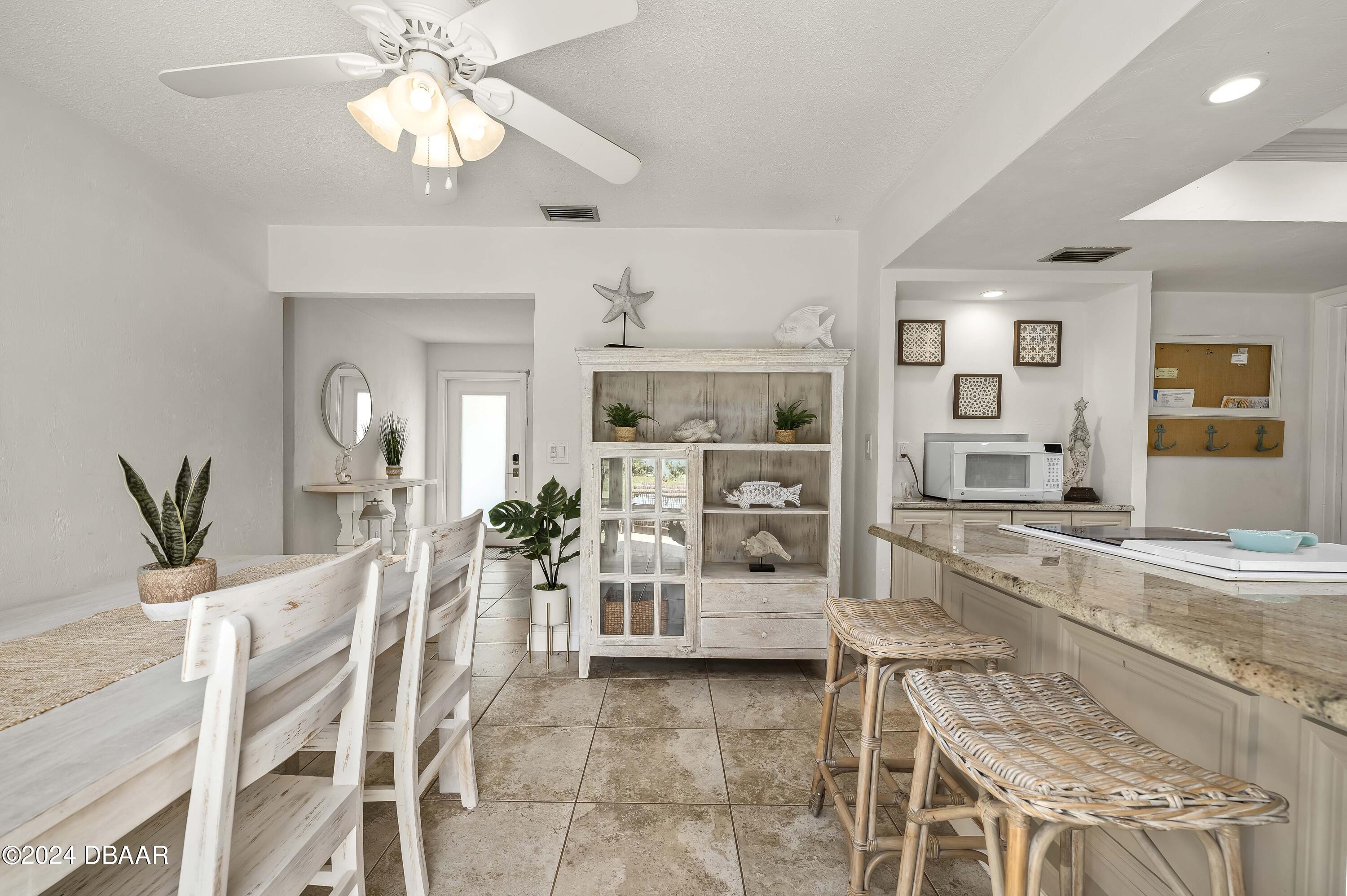 5528 Riverside Drive Port Orange, FL 32127 - Photo 11 of 31 a large kitchen with a table and chairs