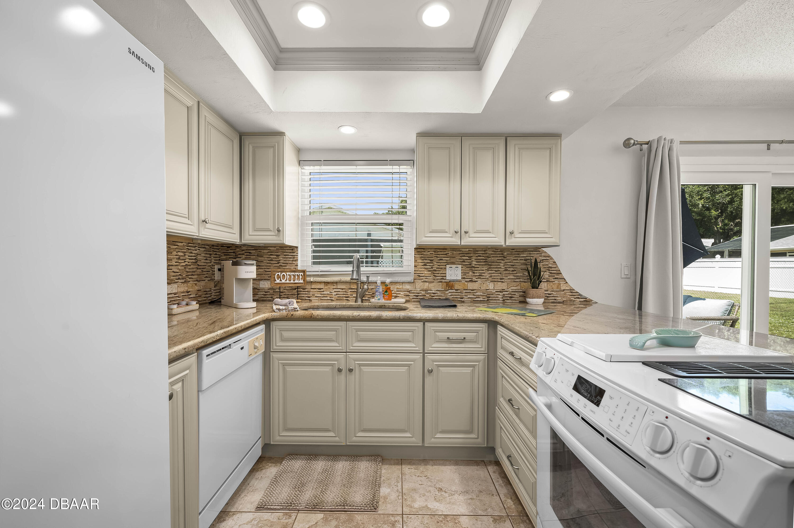 5528 Riverside Drive Port Orange, FL 32127 - Photo 14 of 31 a kitchen with a sink stove top oven and cabinets