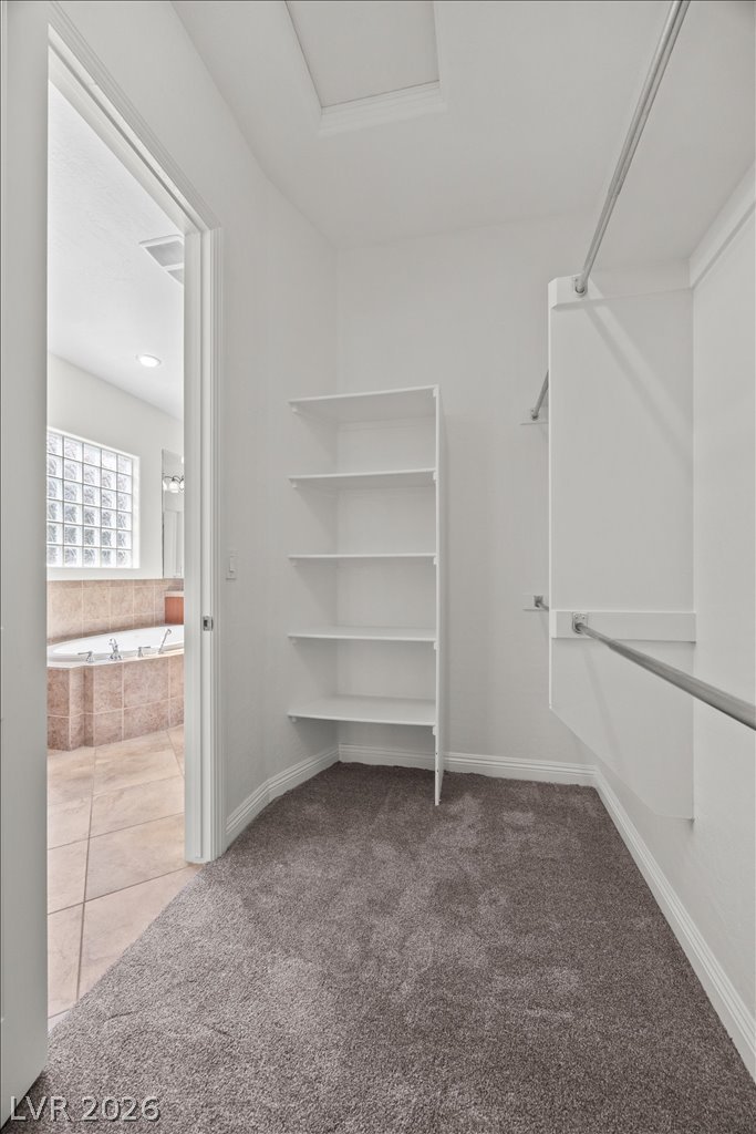 2125 De Rouge Avenue Henderson, NV 89044 - Photo 46 of 96 Ample shelving and hanging space in this well-appointed closet, conveniently adjacent to a tiled bathroom oasis.