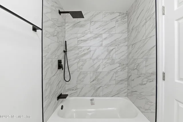 a bathroom with a bath tub and shower