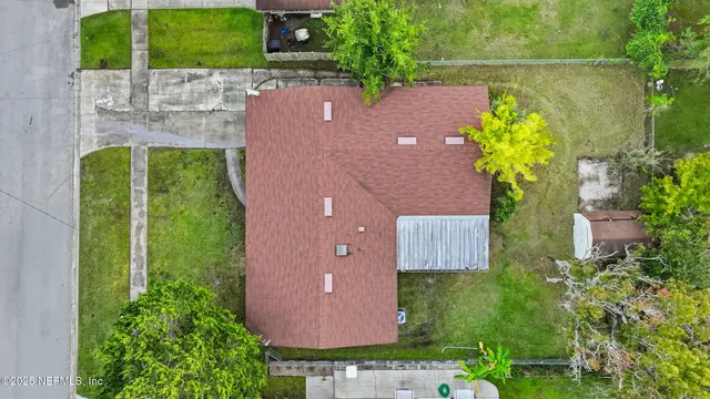 an aerial view of a house with yard swimming pool and outdoor seating