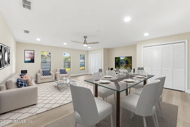 a view of a dining room with furniture and wooden floor