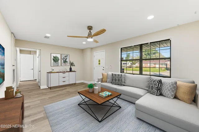 a living room with furniture and a large window